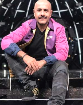 Vishal Dadlani, a dapper gentleman ascending a staircase with flair.